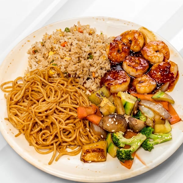 A plate of hibachi shrimp with fried rice, lo mein noodles, and mixed vegetables.